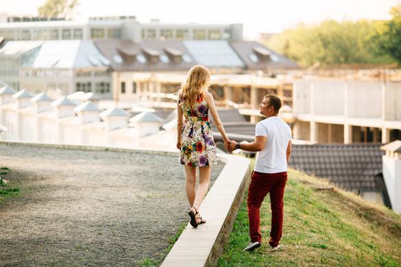 Attractive young couple lovely walking in the city and looking each other