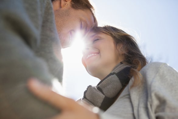 Cute couple hugging in the park on a sunny day