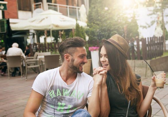 Flirting-couple-holding-hands-at-the-cafe-3