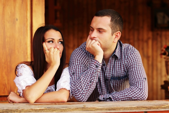 Young thinking couple looking at each other