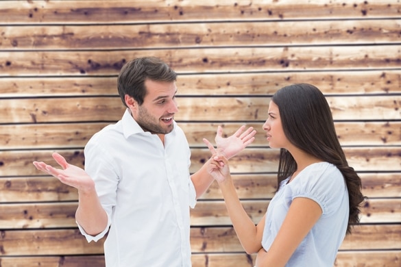 Angry brunette accusing her boyfriend against wooden planks background - Taurus Man And Gemini Woman Breakup